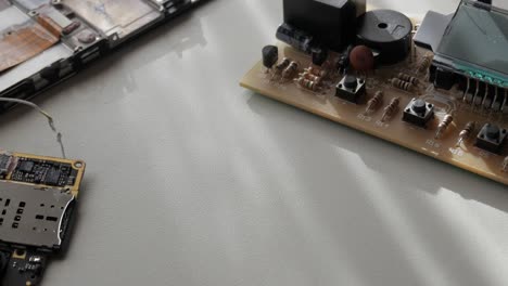 close-up of electronic components on a table, including circuit boards and wires