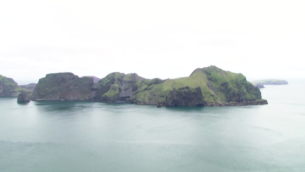 Spectacular aerial view of Icelandic green cliffs and serene ocean