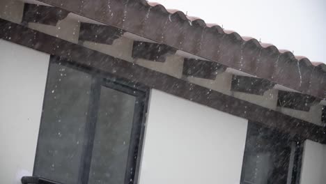 rain falling in the roof of a house in a suburban setting - slowmotion