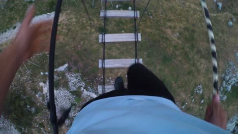 man walking on high rope obstacle in lebanon, stepping on small wooden planks