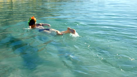 woman swimming in the water at beach 4k