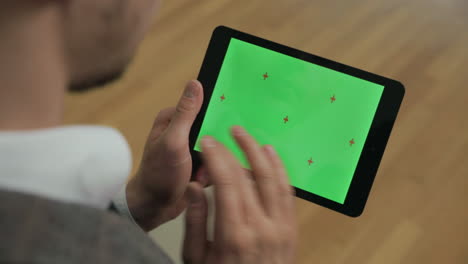 male hands swiping tablet green screen. man touching chromakey screen on tablet