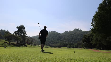 golfer performing a full swing on a golf course