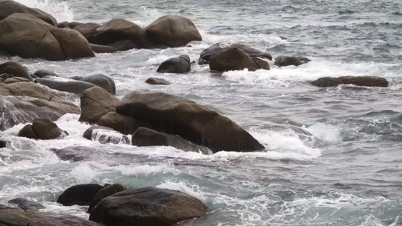 Waves Crashing Against Rocks on a Seashore