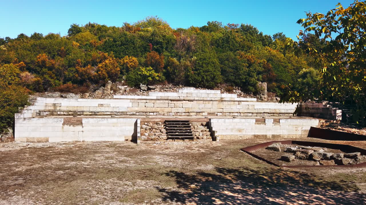 Ancient construction excavations on a hill with greenery around in Greece