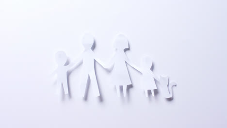 close up of family with cat made of white paper on white background with copy space