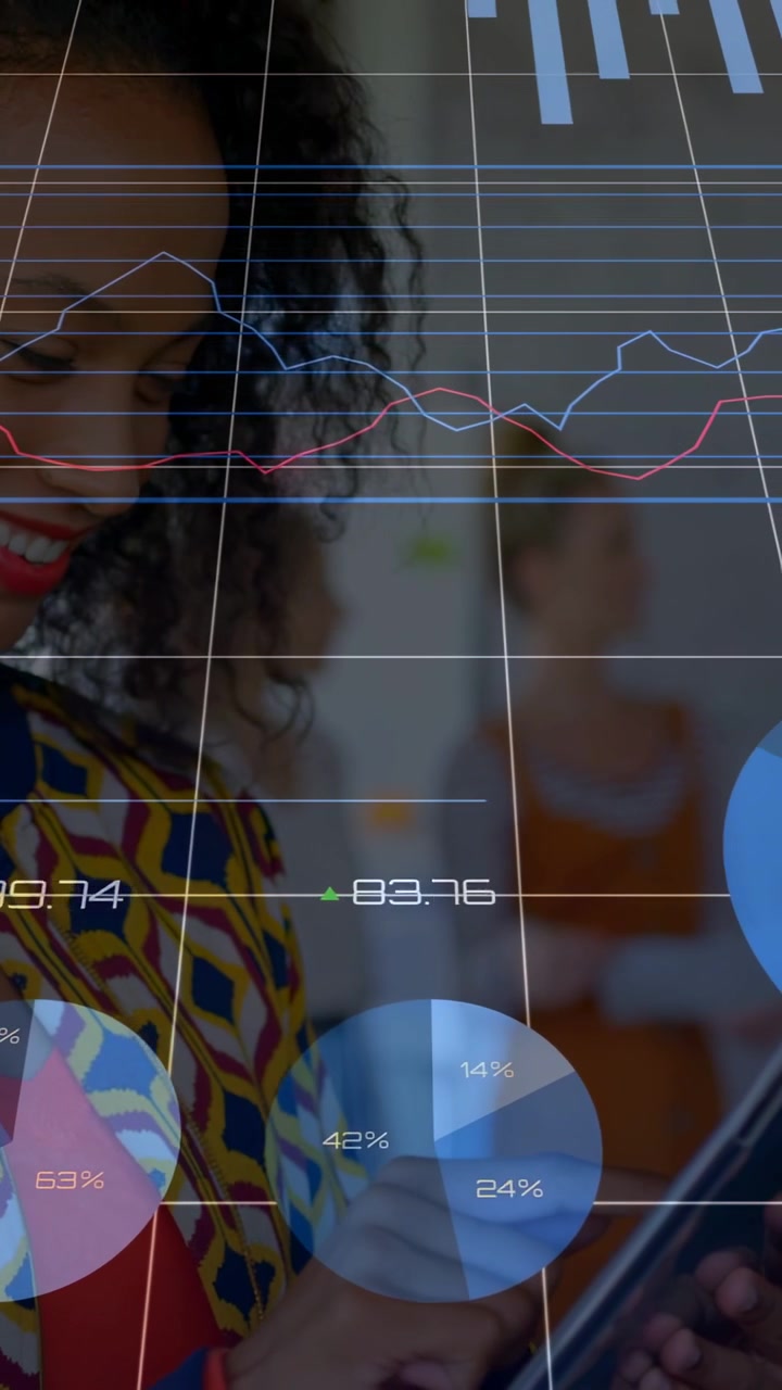 Vertical video: Woman tapping tablet in office causing business charts animating for metrics review