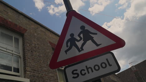 school children crossing street warning sign
