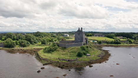 aerial shot rotating around dunguaire castle in county galway, ireland