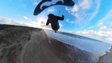 thrilling fpv view of paraglider speed soaring over dutch coastal dunes