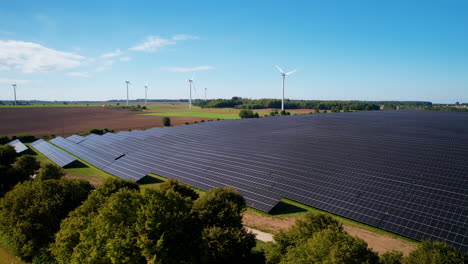 slide sideway on solar panels and wind turbine in rural landscape