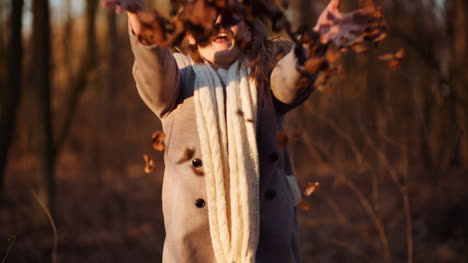 positive happy woman throwing leaves in autumn in park 2