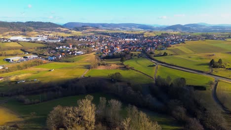 bird's-eye view of a sprawling village amidst verdant agricultural land