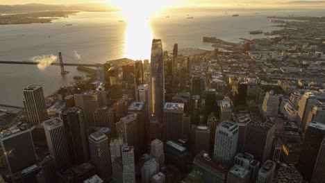 bird-eye view of downtown san francisco with sunbeam reflection on water at dawn