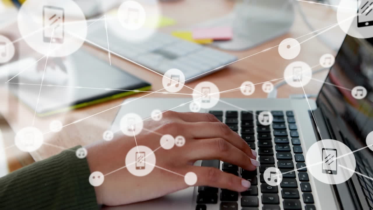 Typing on laptop, animated multimedia icons connecting over office desk