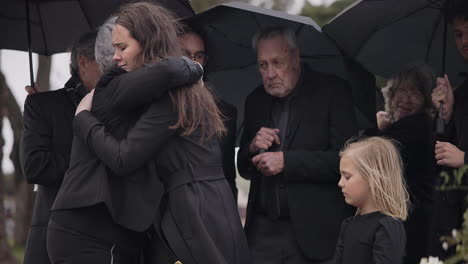 funeral, crying family and people hug for grief