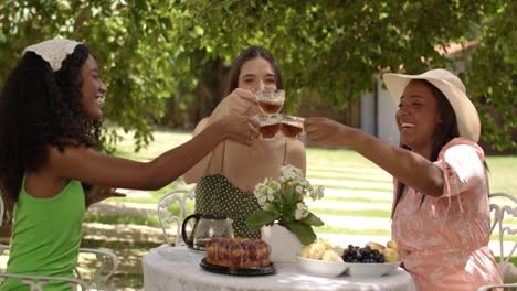 Three Friends Enjoying an Outdoor Tea Party in a Garden