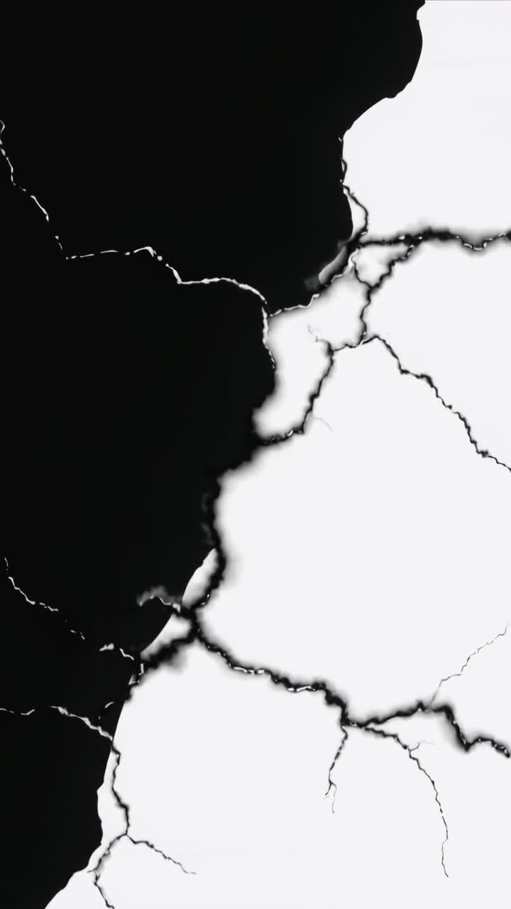 Vertical video: Showing frames, white cracks creeping right in digital, dark veins near jagged edge