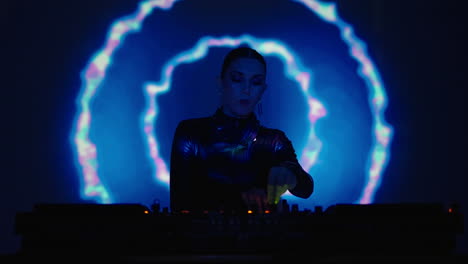 female dj performing at a nightclub with blue and purple lighting