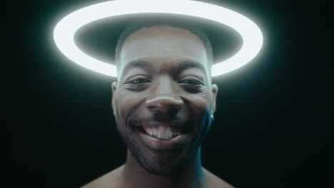 Smiling Black Man Posing with Ring Light Above the Head