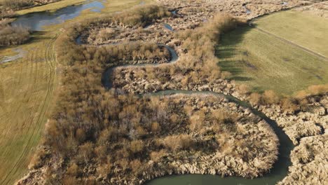 Aerial-drone-view-of-s-curve-shaped-river,-aesthetic-elegant-shot