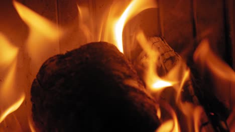 burning flame at fireplace on wooden logs