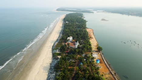 aerial drone shot of a scenic island and coconut tree village in udupi