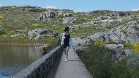 A-woman-dances-on-the-walkway-at-Covão-dos-Conchos