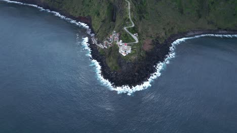 Cliff-lighthouse-mountain-road,-ocean-coastline,-Azores-Portugal-Drone-Landscape