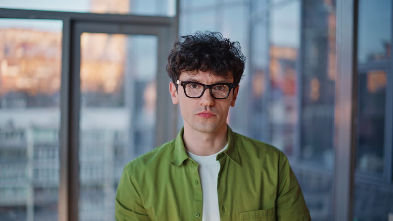 Modern startuper posing office panoramic window closeup. Portrait man manager