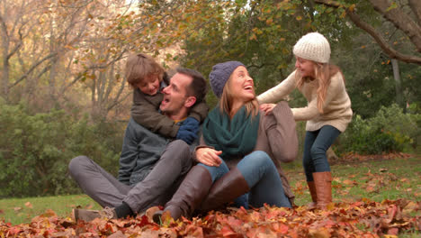 Pow-and-wow-text-on-speech-bubbles-against-family-sitting-in-the-garden