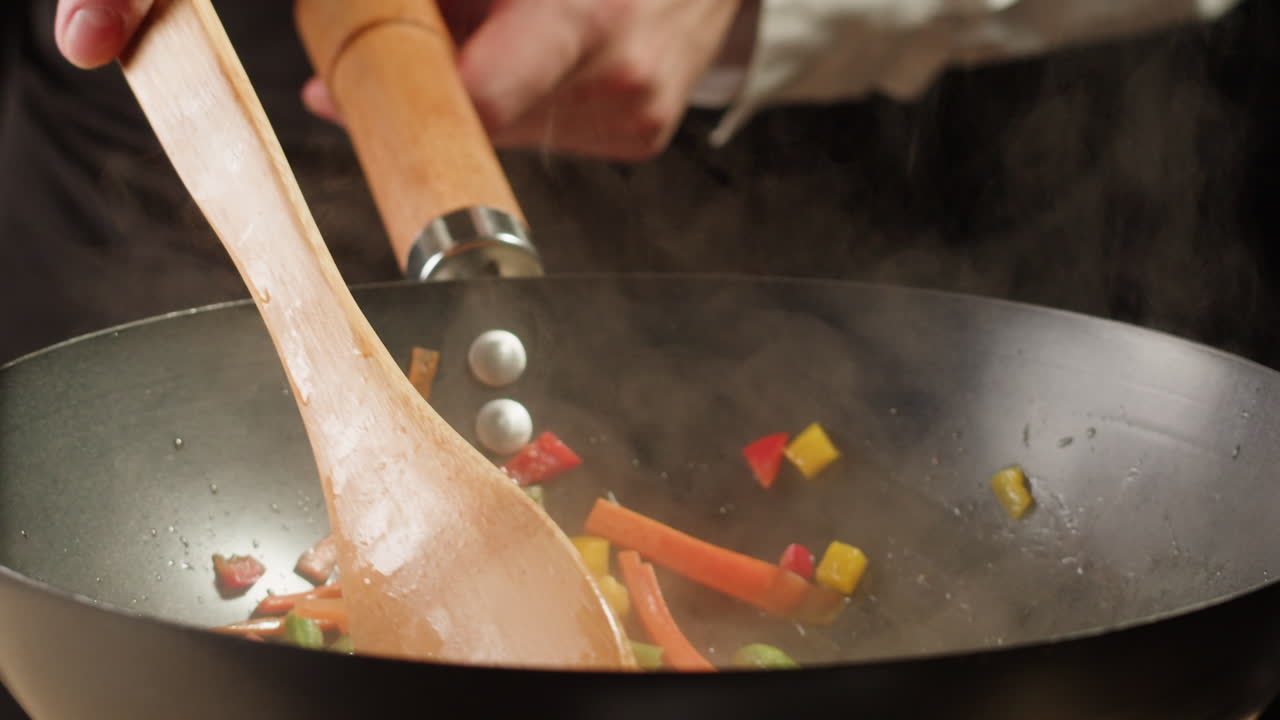 Chef Stir-Frying Vegetables in a Wok