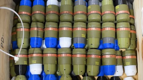 colorful, modified grenades with plastic casings, destined for military drones, fill a box at a workshop in ukraine's donetsk region. adaptive weapon tech for modern warfare