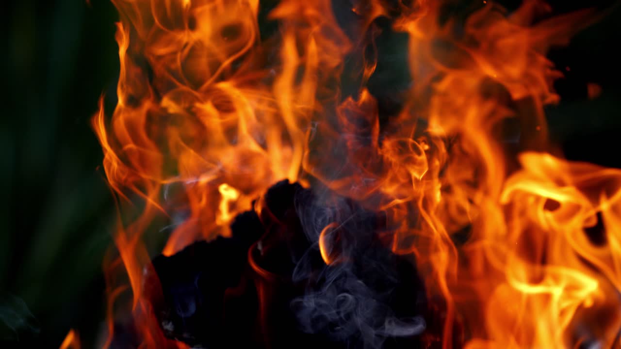 Burning flame close up view. Close up of a large bonfire and textured log