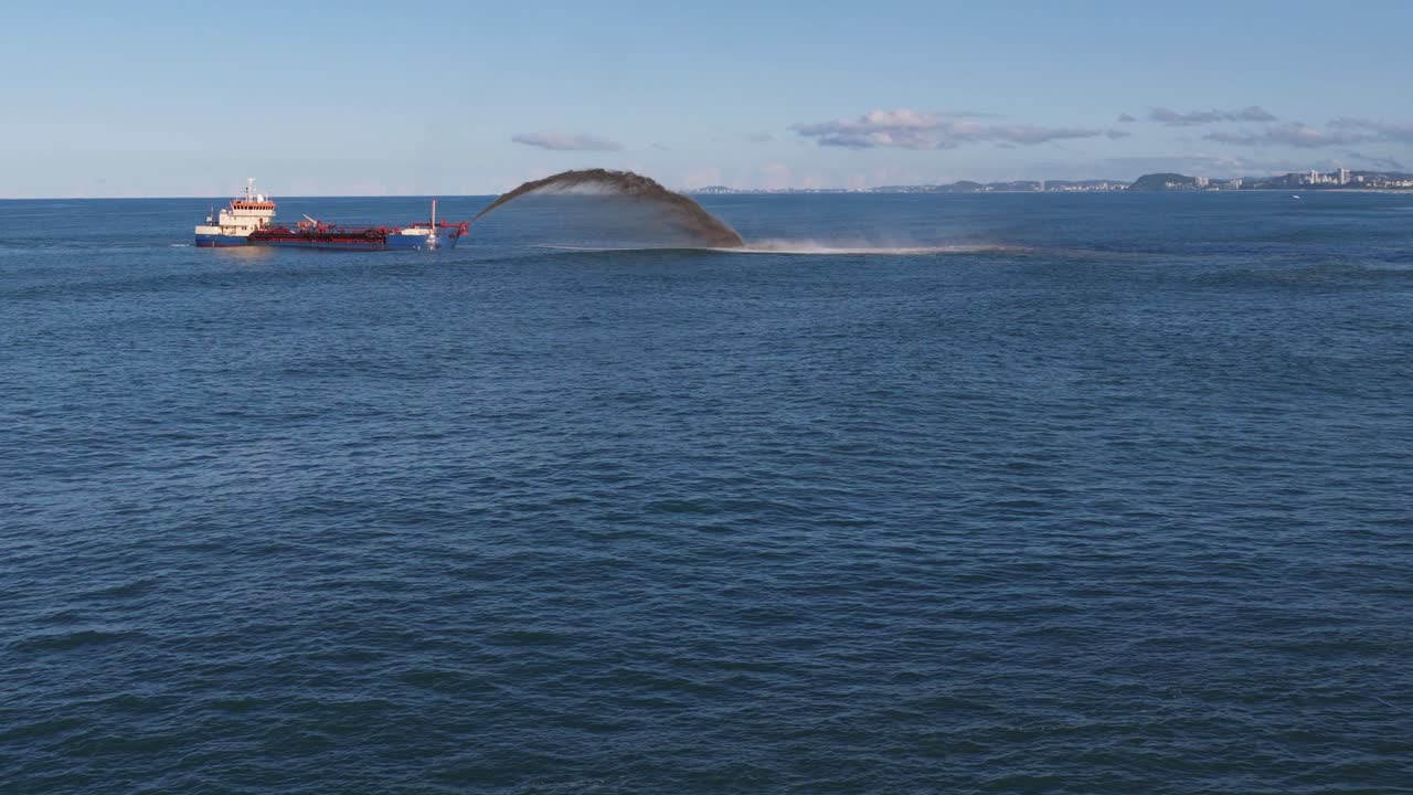 A dredging ship pumps sand into the ocean, restoring cyclone-damaged areas near Surfers Paradise, Gold Coast