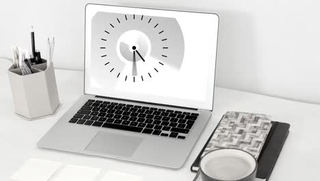 animation of clock moving fast on laptop screen on desk