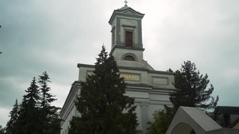 Walking-the-town-center-revealing-church-between-trees