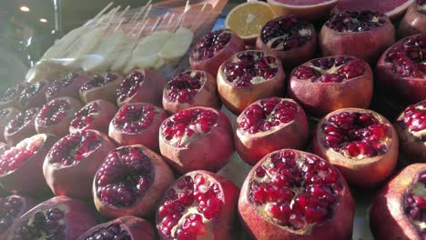 fresh pomegranate and other fruits at a market stall