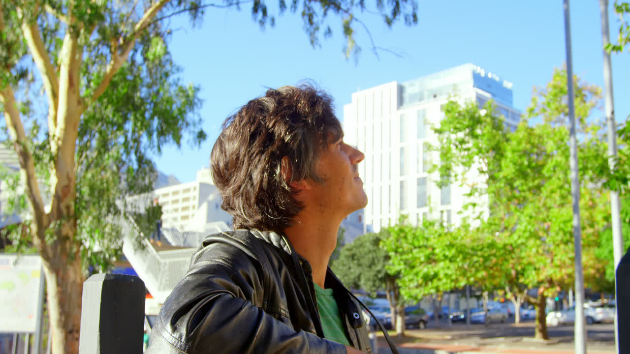 fotógrafo masculino de pie cerca de la calle de la ciudad 4k