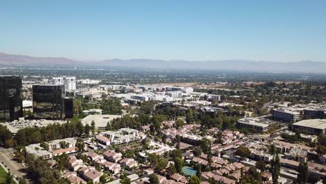 aerial view of suburban cityscape with mountains in the background