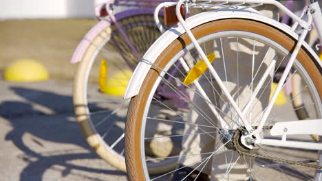 close-up view of the wheel of a white bicycle turning