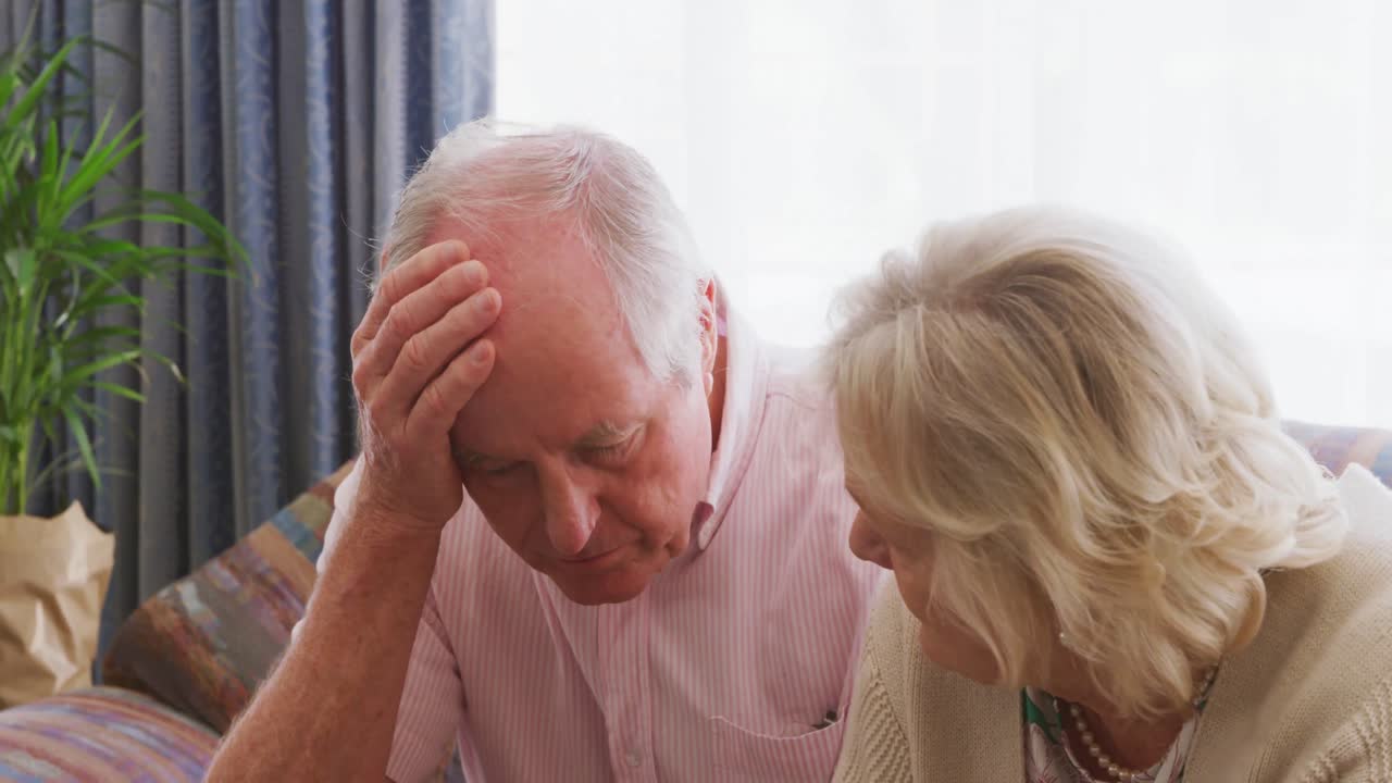 Senior couple in social distancing do administrative work.