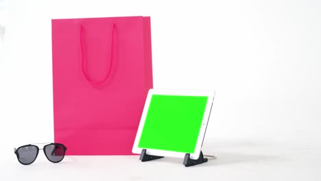 shopping bag, digital tablet and sunglass