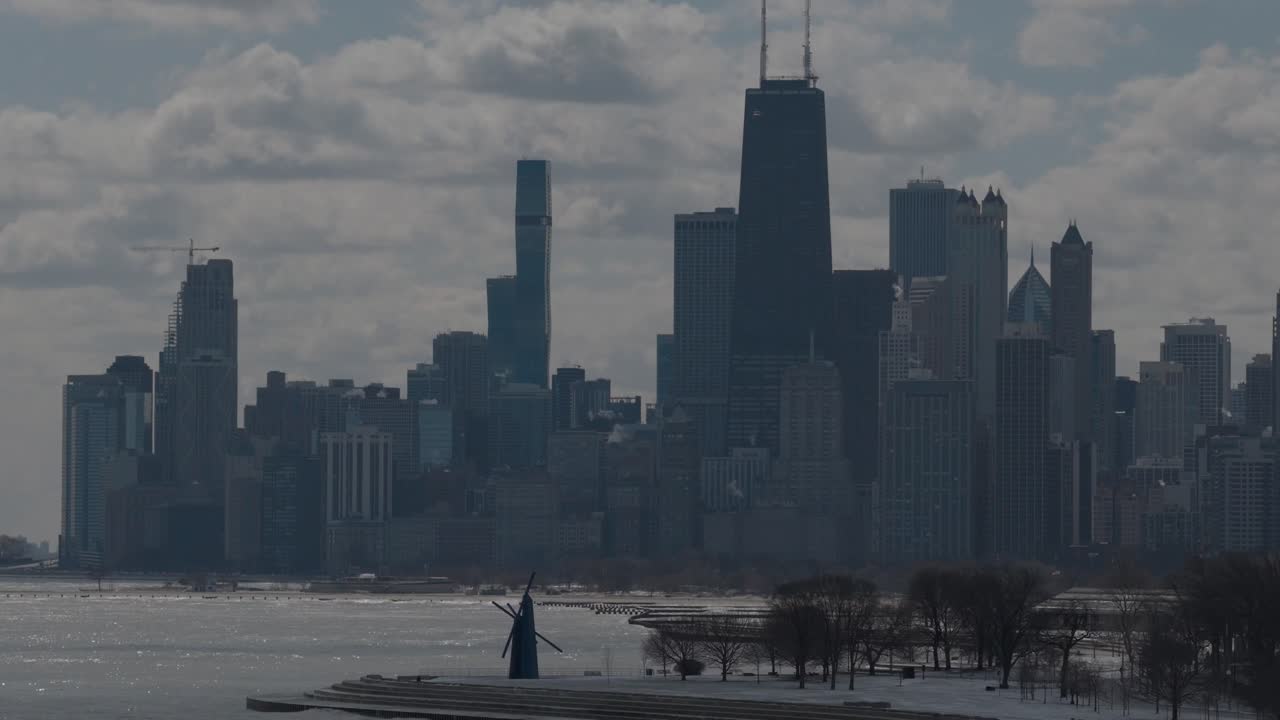 The Chicago Skyline along Lake Michigan in a beautiful descending drone shot of the iconic, towering skyscrapers