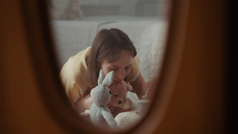 a girl playing with dolls in her room