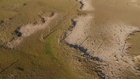 Foams-of-flooding-ocean-wave,-fence-of-a-land-in-the-coastal-beach-of-Rancho-Uruguay