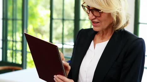 Mujer-De-Negocios-Escribiendo-En-Una-Libreta-En-Un-Restaurante-4k