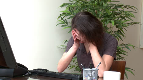 tired woman working at a computer