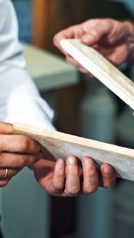 customer checking marble stone. close up of man advising customer on the purchase of marble vertical video