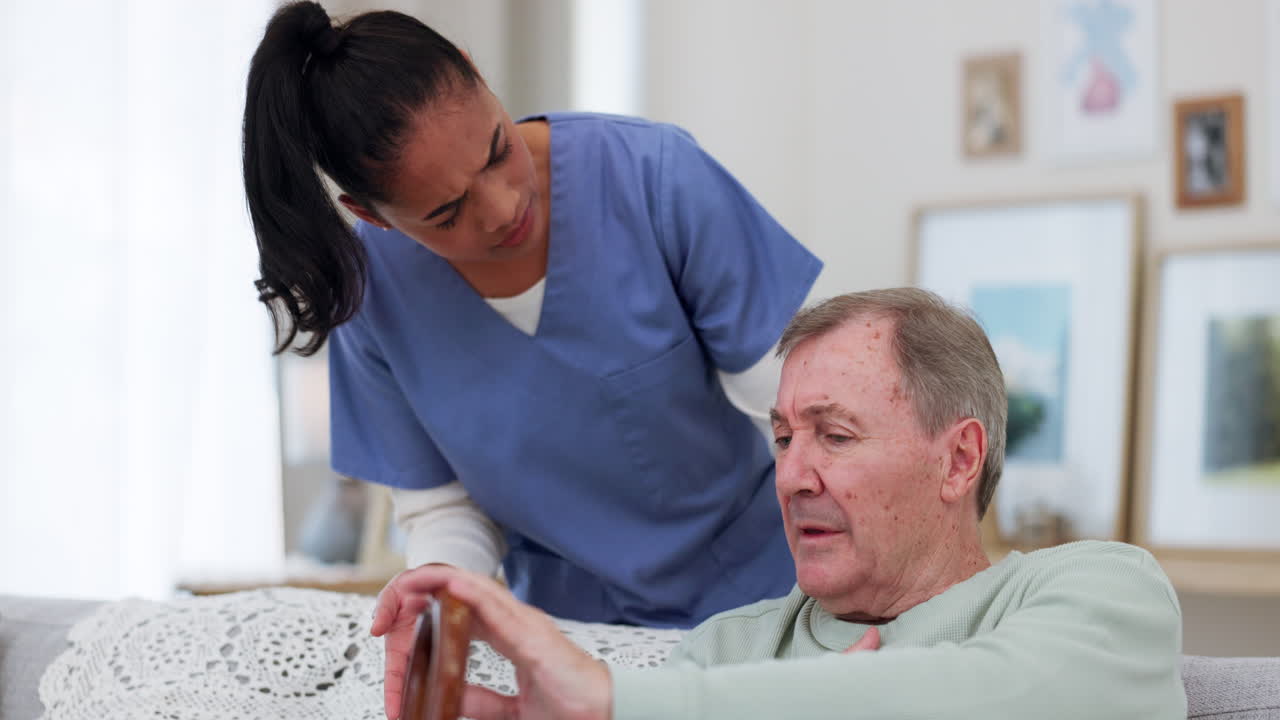 Caregiver, senior man and talking on sofa